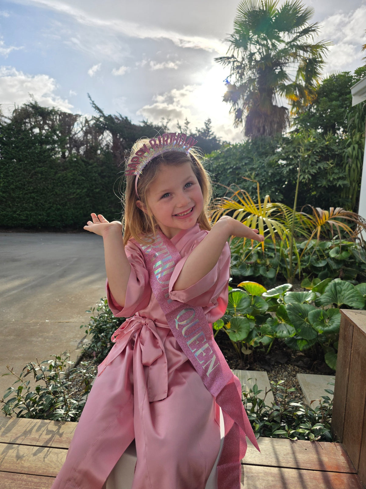 Birthday Child Luxe Upgrade lifestyle image with pink satin robe, birthday headband and sash